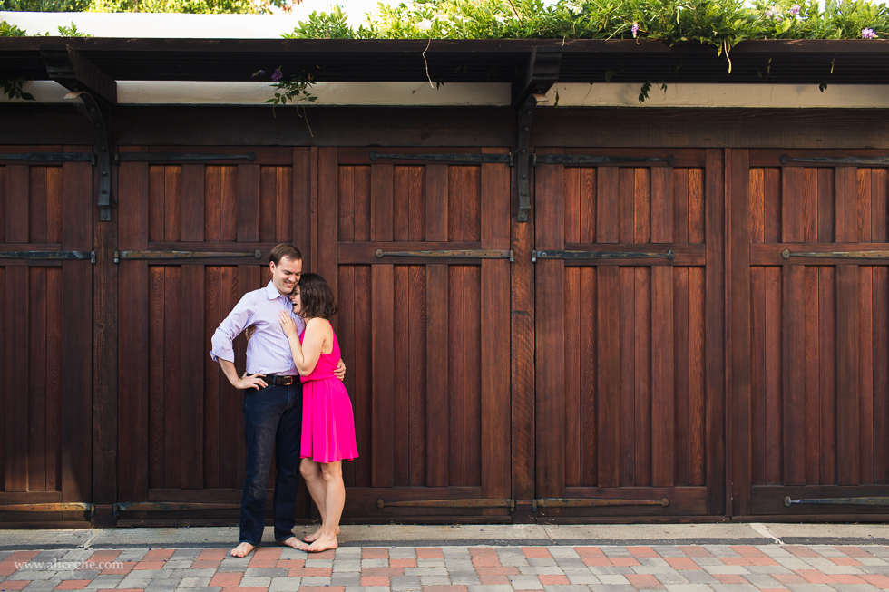 Engaged couple in front of wooden doors at Palo Alto engagement session