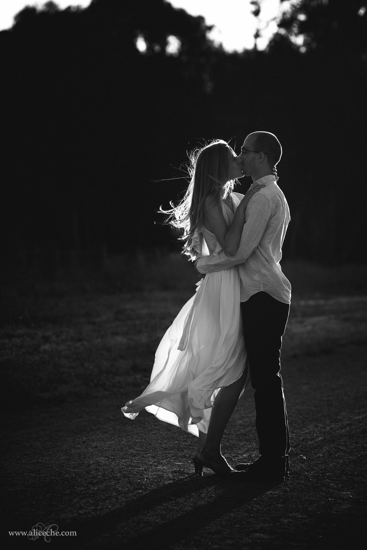 Palo Alto Engagement Photographer Black and White Kissing Couple Wind in Hair and Flowy Dress