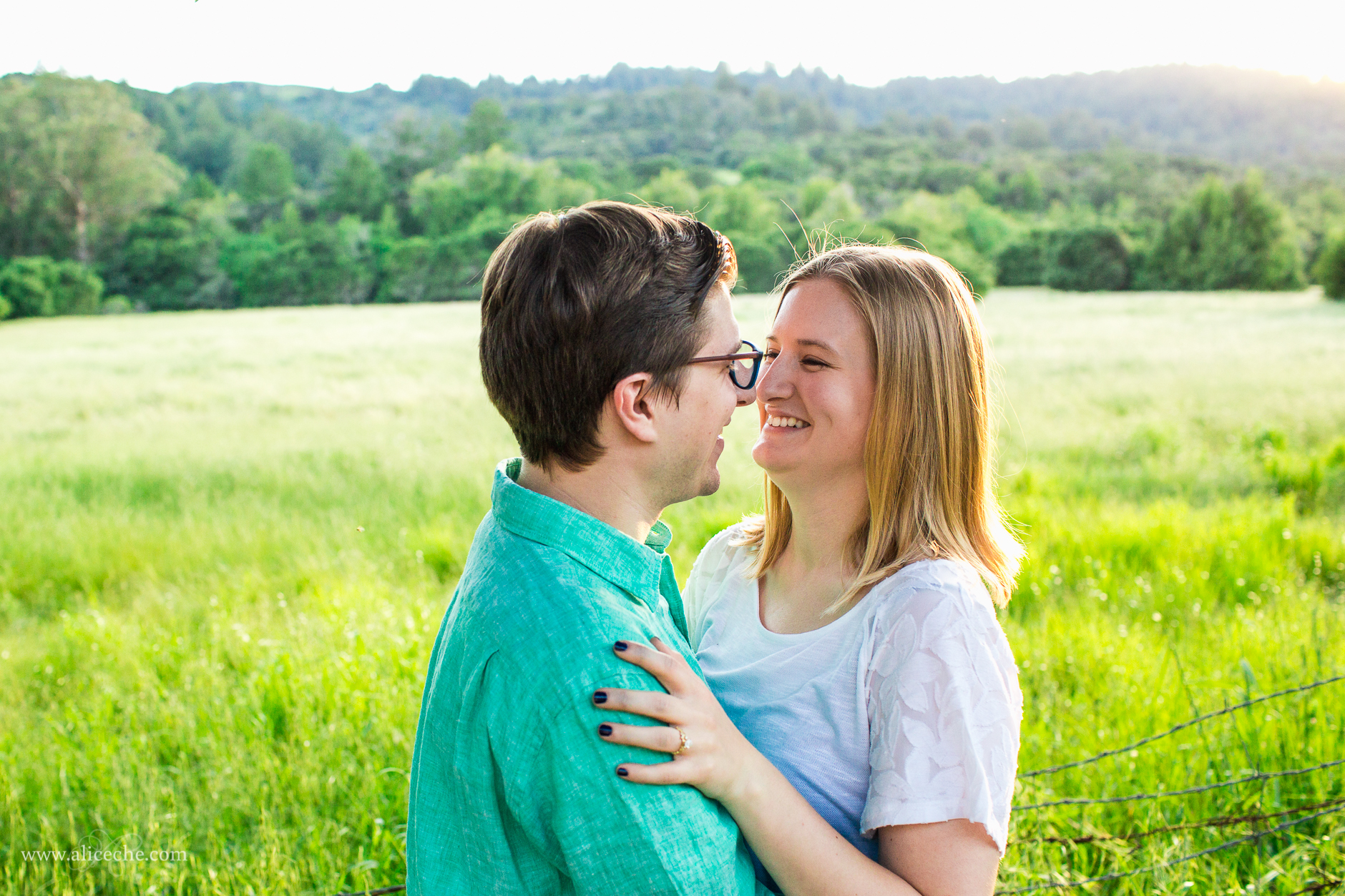 laughing couple in front of field adorable windy hill engagement session