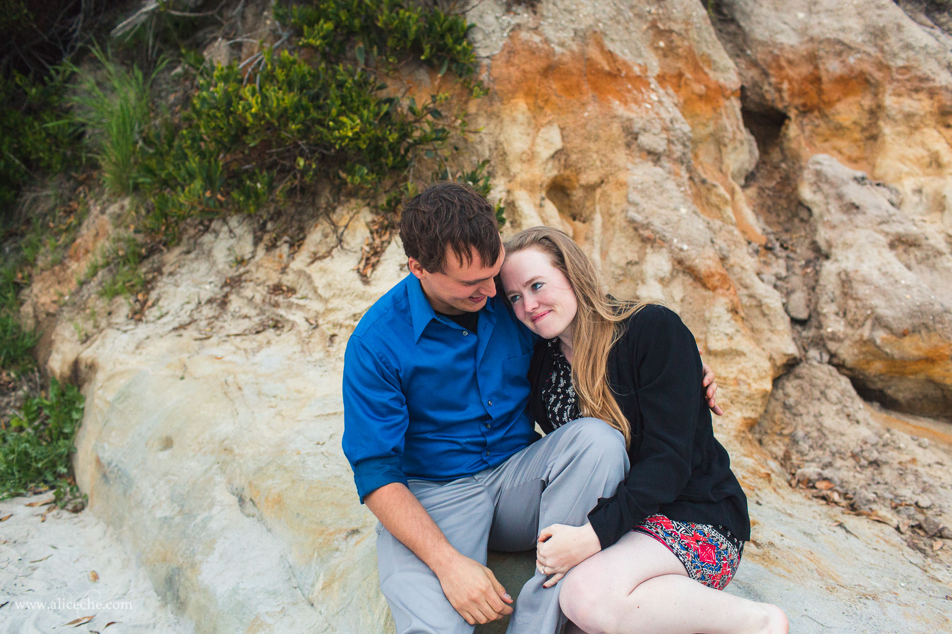 carmel beach proposal san francisco bay area photographer couple cuddling on rocks