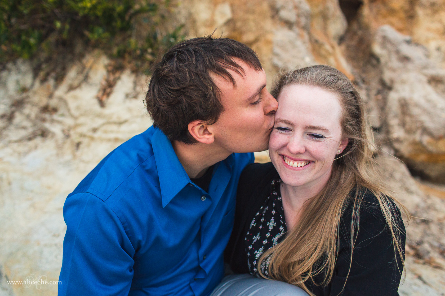 carmel beach proposal san francisco bay area photographer guy kissing fiance on temple
