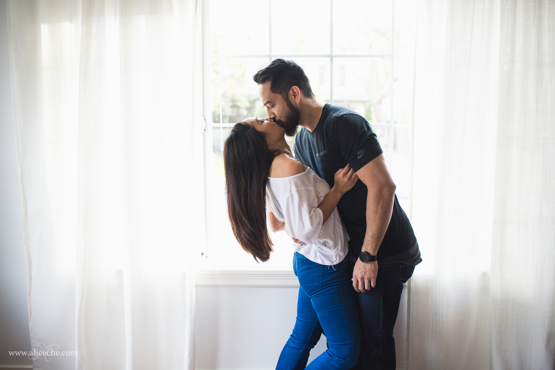 san francisco intimate at home engagement couple kissing in front of window