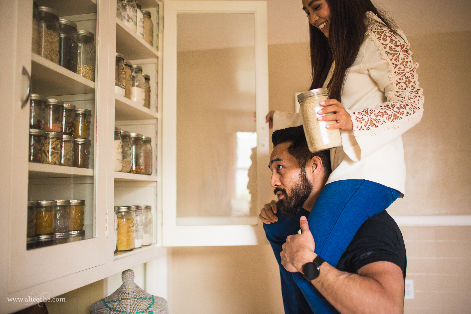 san francisco intimate at home engagement couple guy helping girl reach high shelves