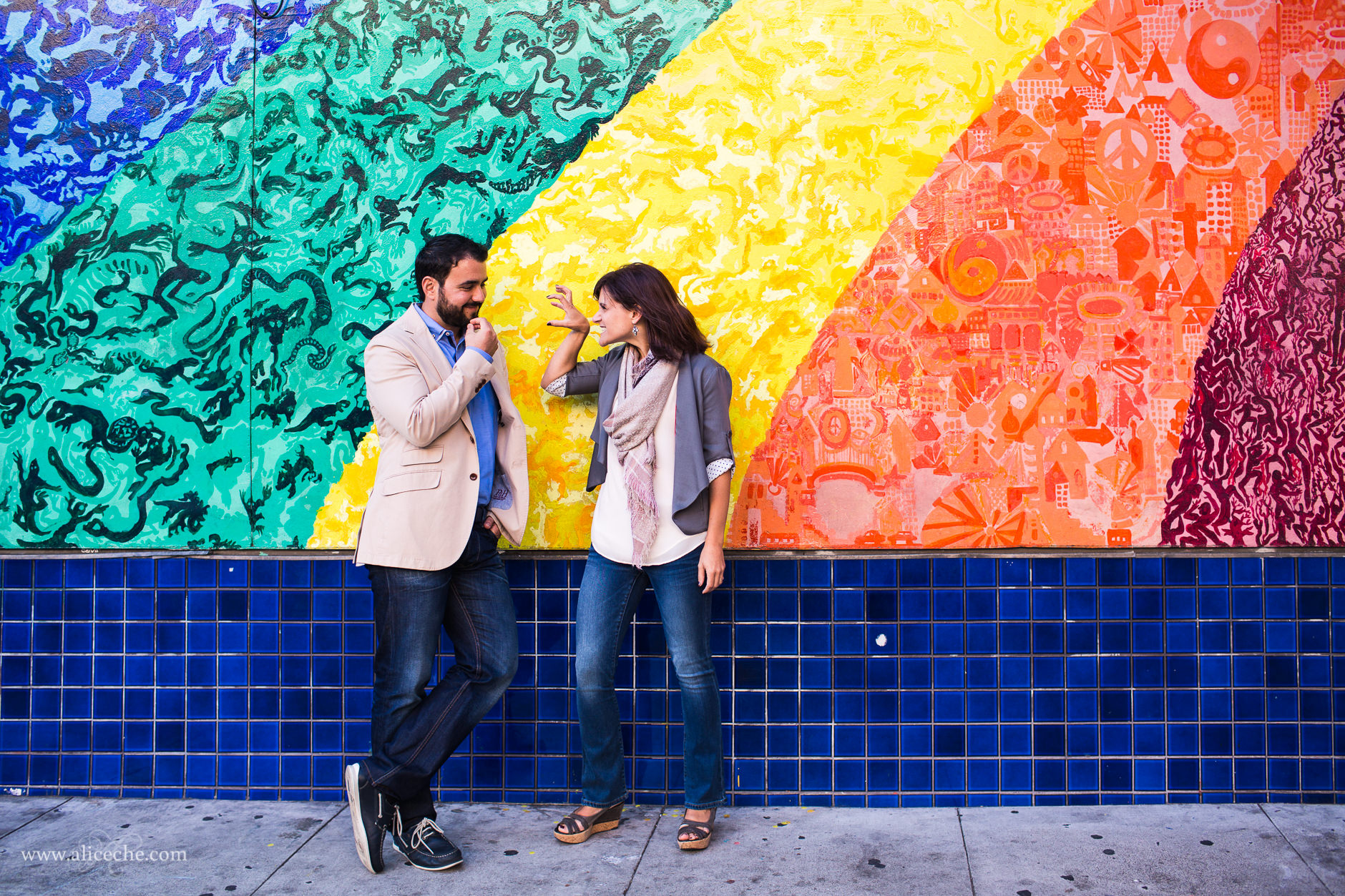 haight-ashbury-engagement-session-san-francisco-wedding-photographer-couple-laughing-in-front-of-rainbow-mural
