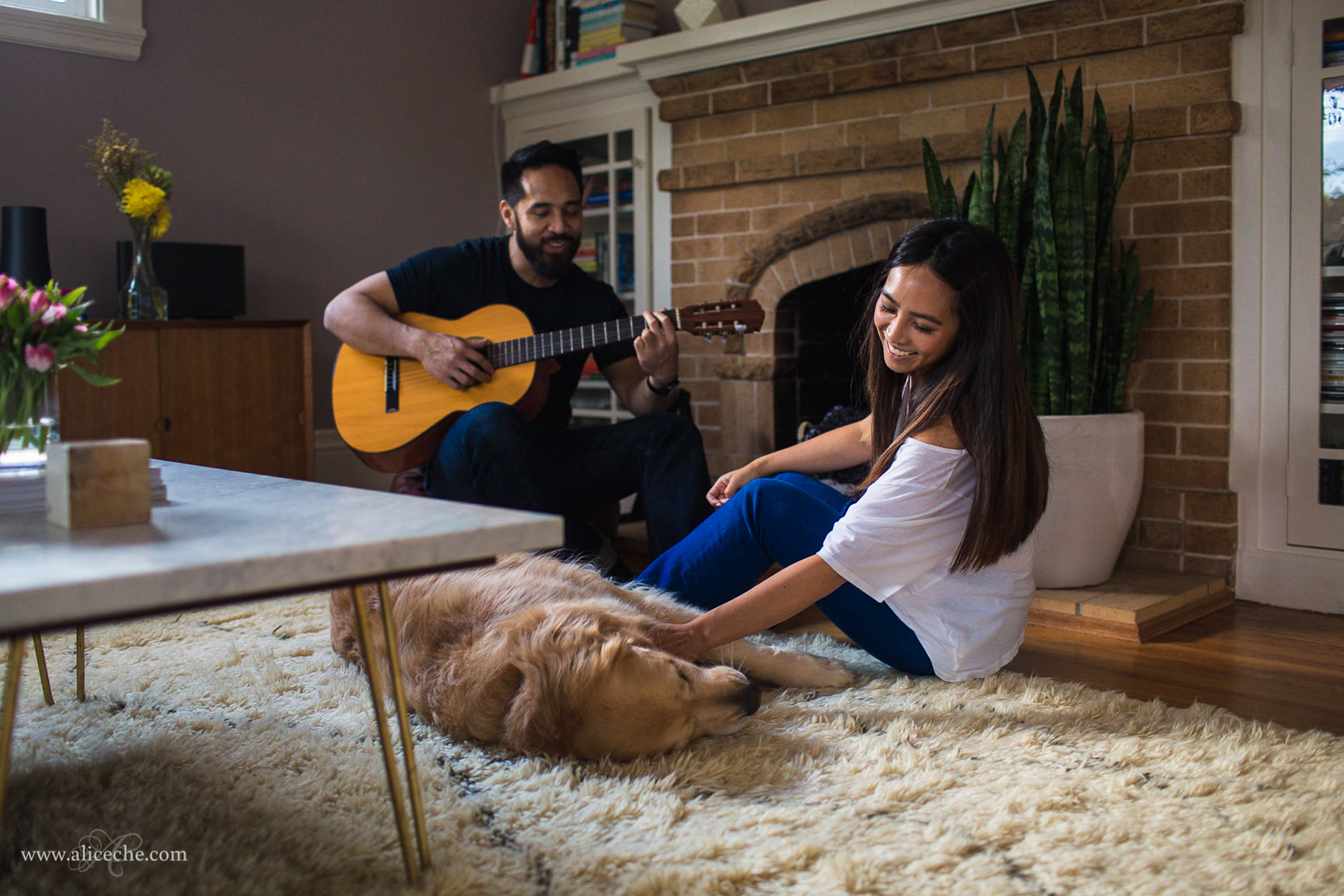 San Carlos In Home Engagement Session Guy Playing Guitar and Fiancee petting Golden Retriever
