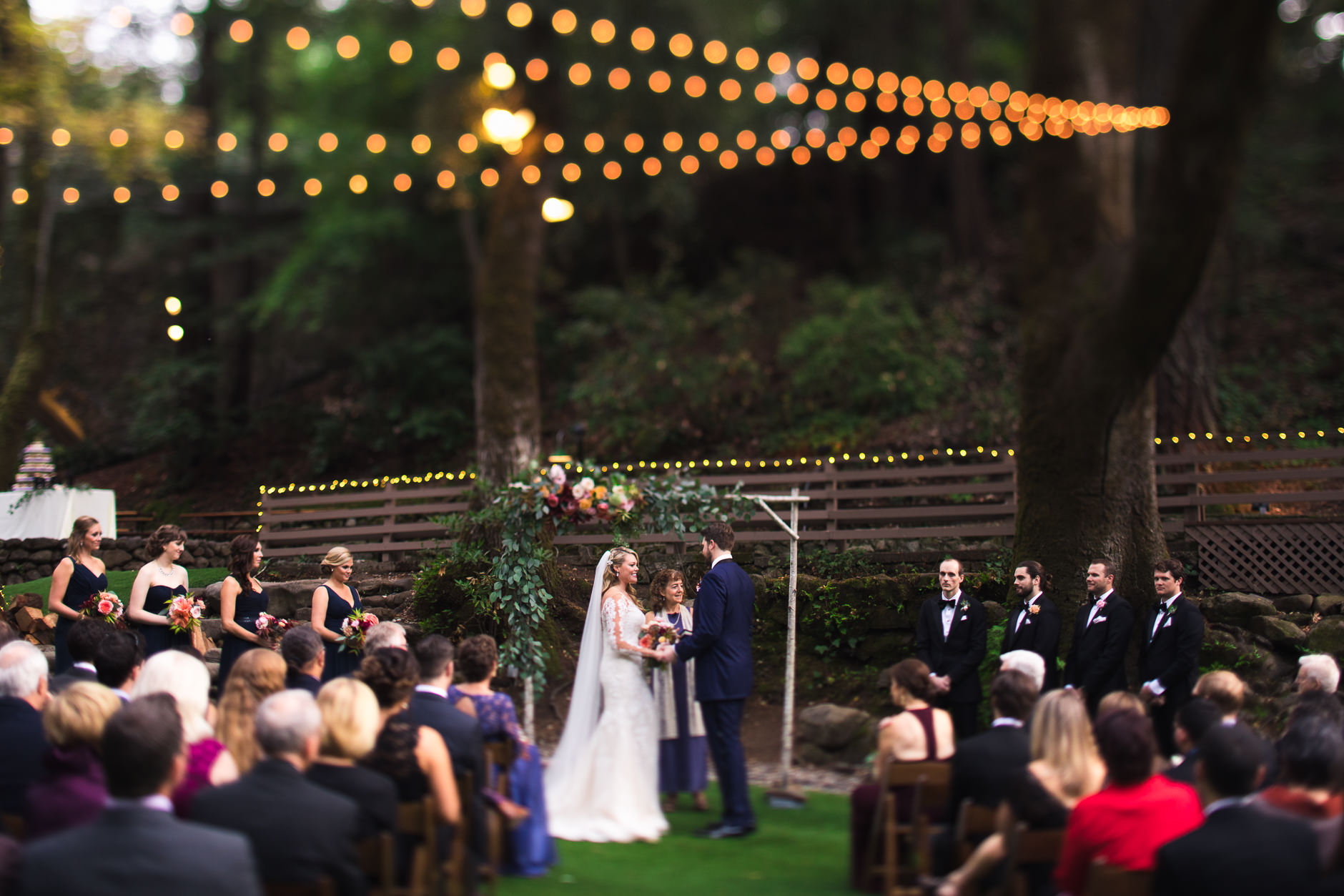 Saratoga Springs Wedding California San Francisco Photographer Bride and Groom during Ceremony under Redwoods and String Lights