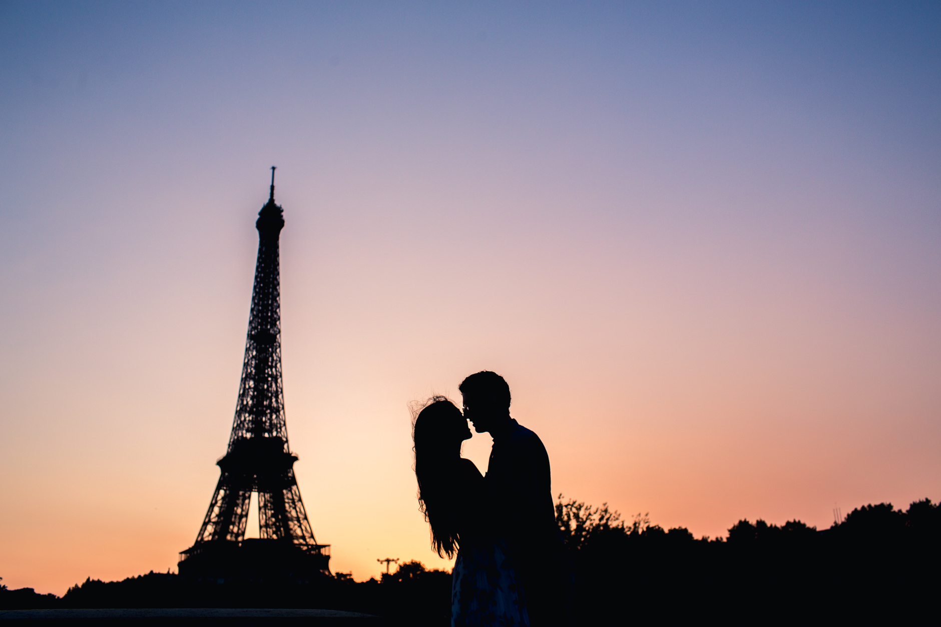 Sunrise in Paris Couple Kissing in front of Eiffel Tower Silhouette Destination Wedding Photographer