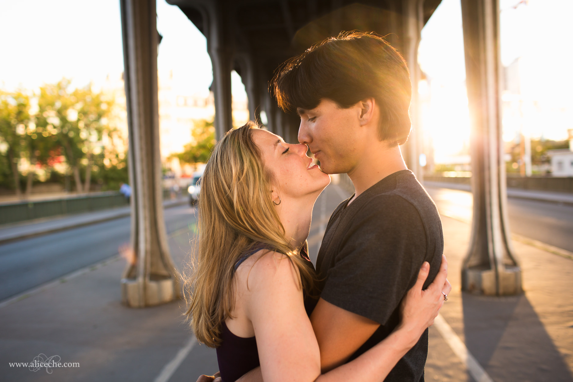 Paris Engagement Session Couple Kissing under Pont de bir Hakeim