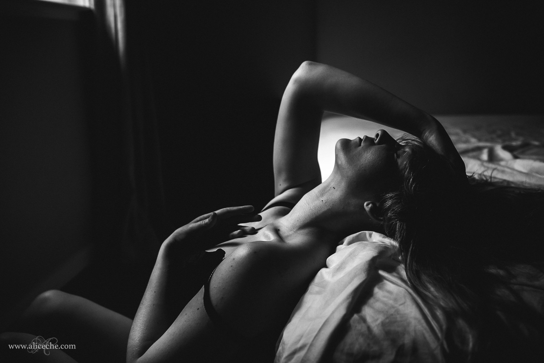 San Francisco Boudoir Photographer Moody Woman Against Bed