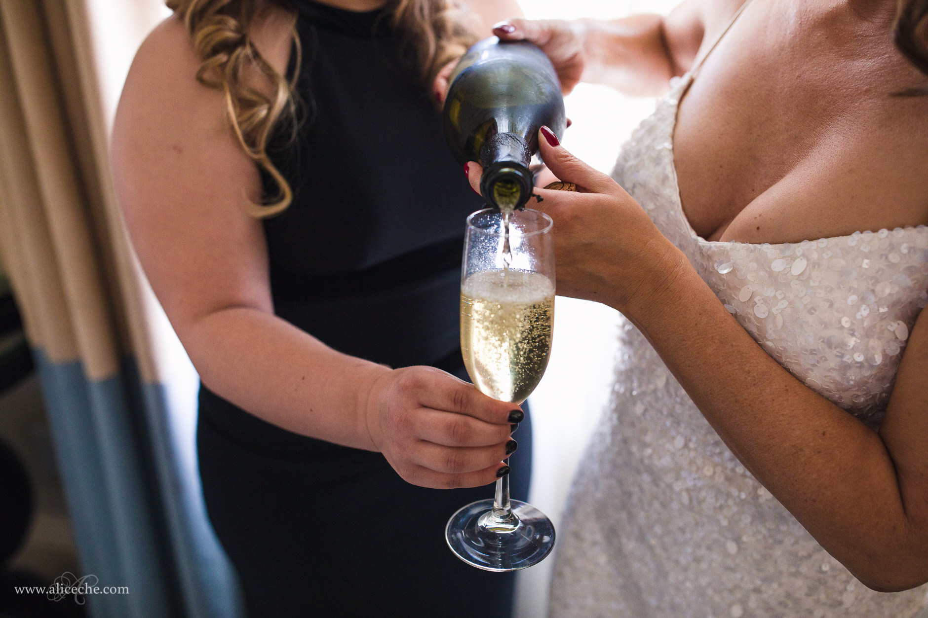 Bride pouring champagne before New Year's Eve wedding