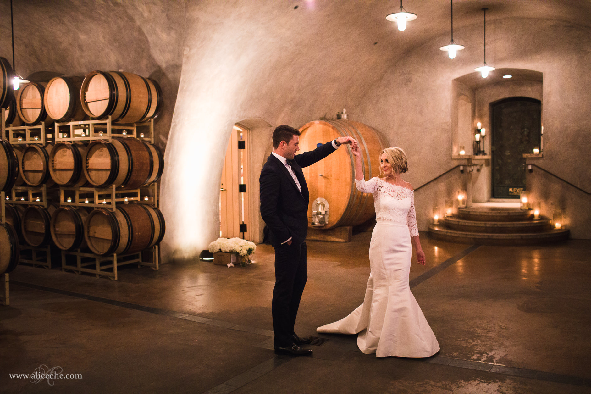 Viansa Winery Sonoma Wedding Bride and Groom Dancing in Wine Cellar Lit with Candles