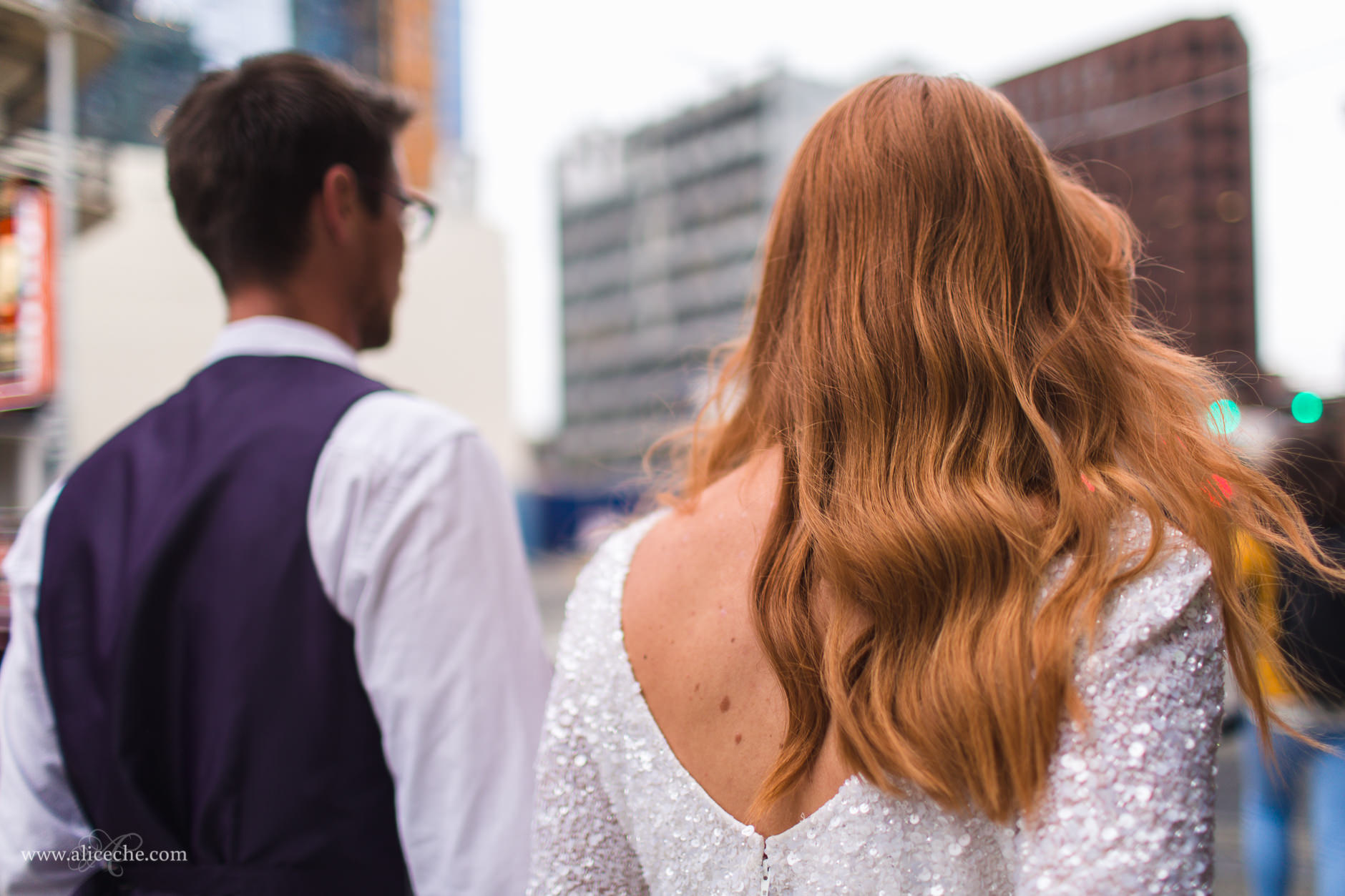 Red Haired bride and groom walking downtown