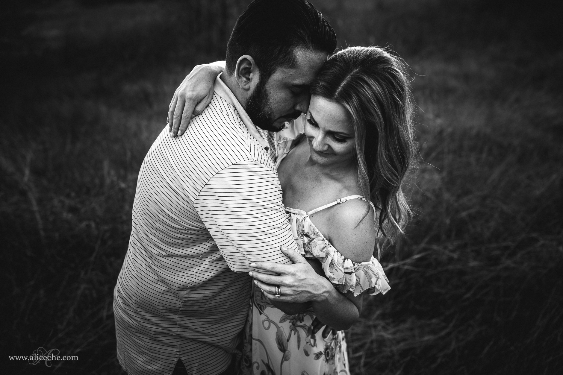 Couple Portraits in a Field Guy Hugging Wife in Cold Shoulder Dress