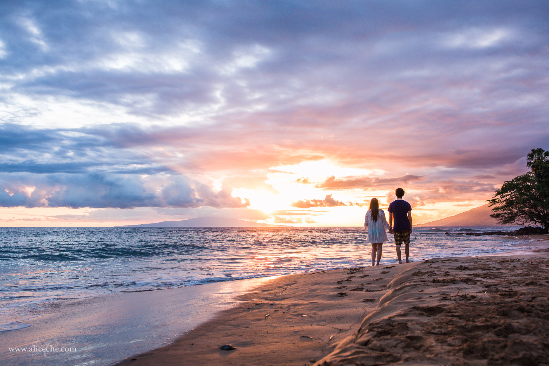 Couple walking on Ulua Beach at sunset in Maui