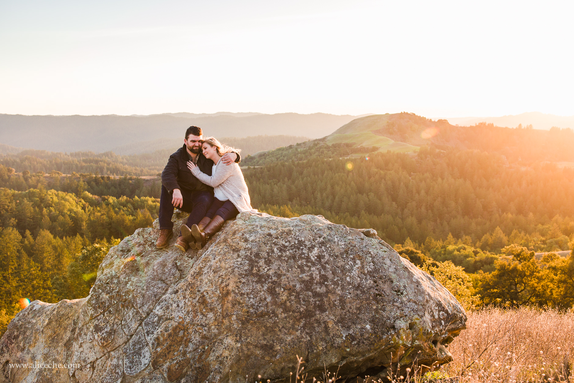 Couple in golden light on top of a rock