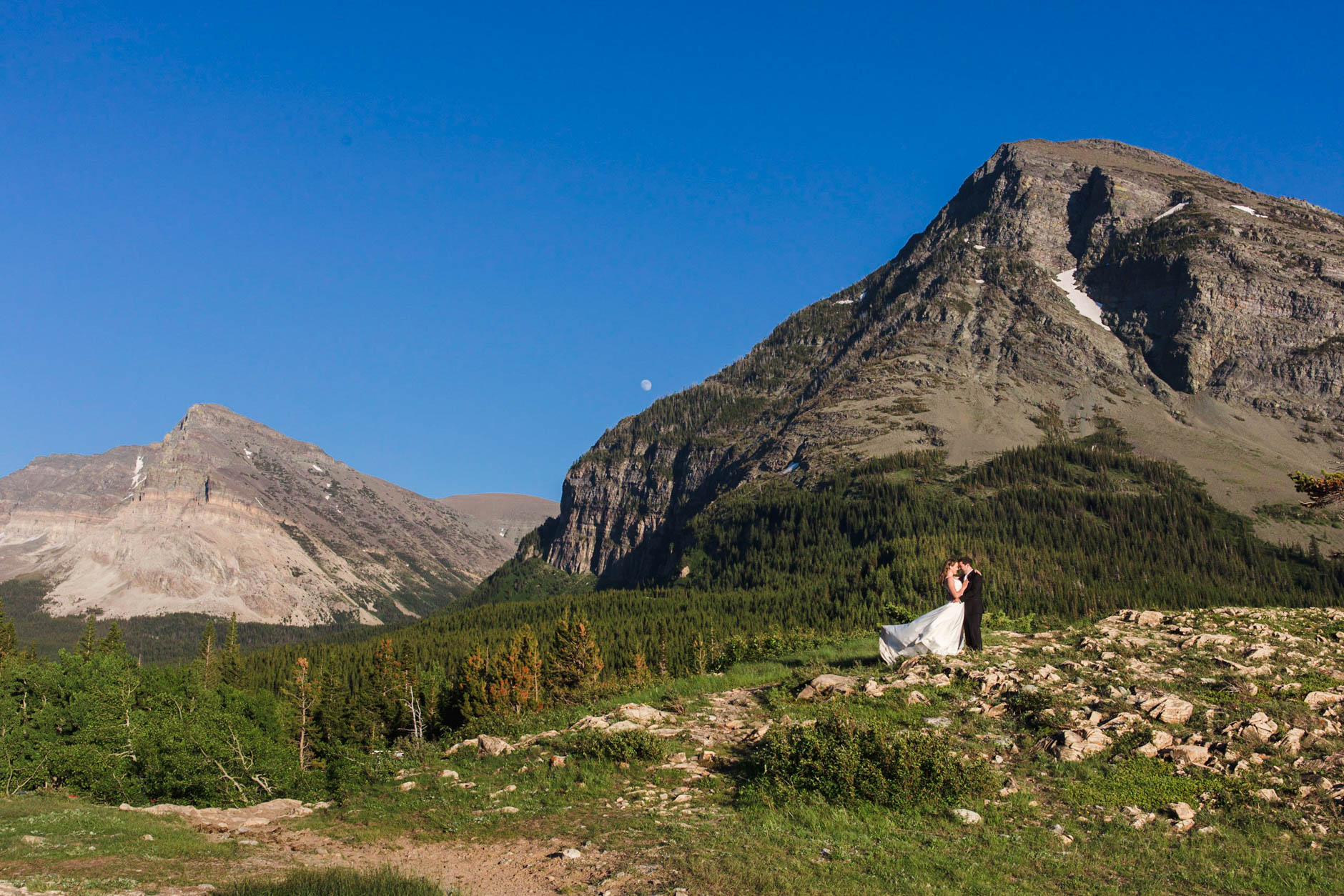 Bride and Groom on top of the hill in Many Glacier National Park