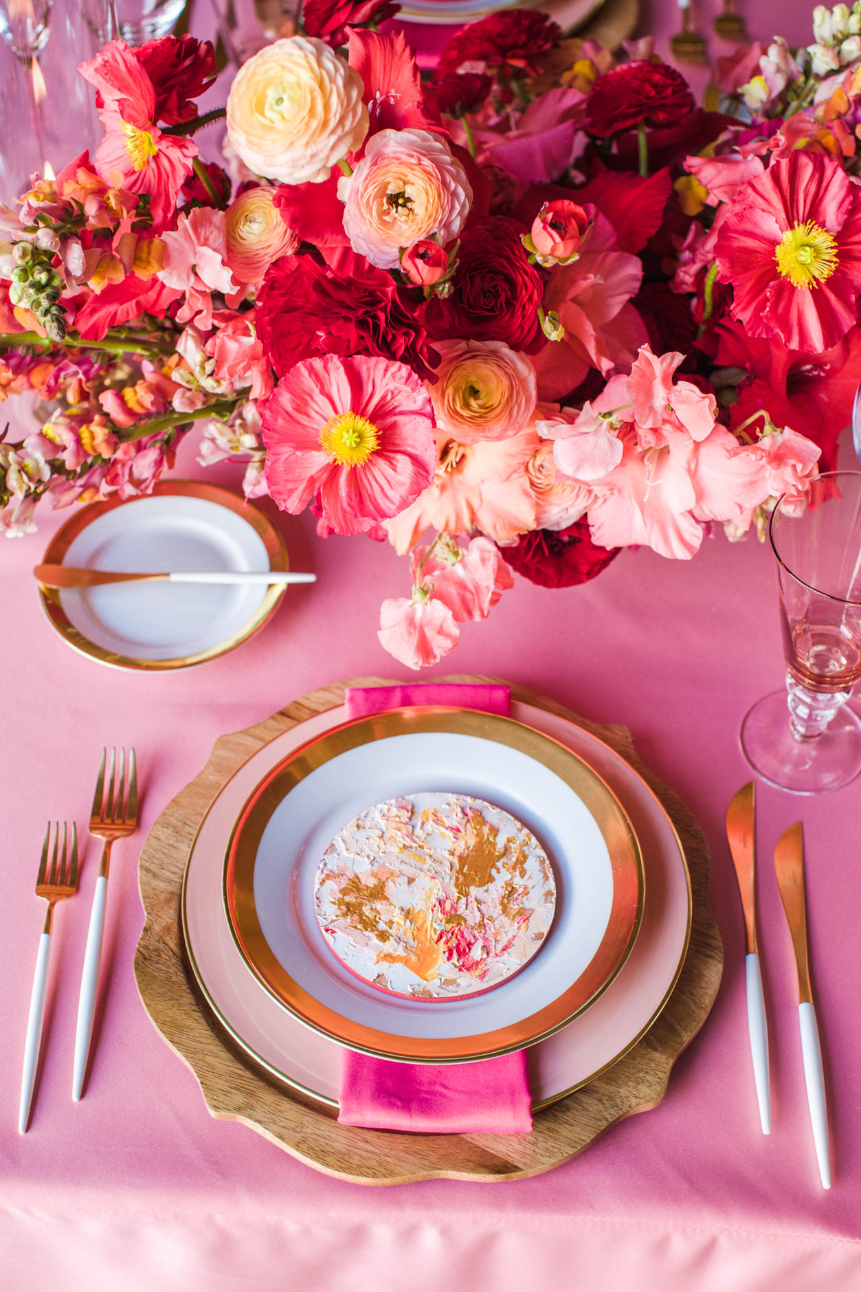 Beautiful place setting with bright pinks, icelandic poppies and hand-painted menu.