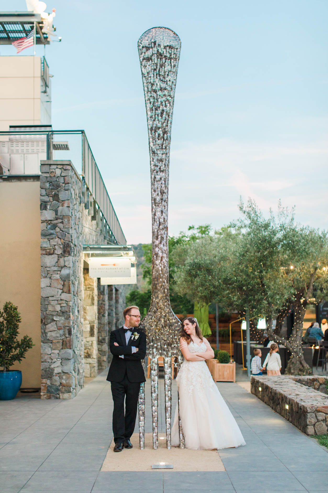 Bride and Groom at CIA Copia Wedding leaning against big fork made of forks