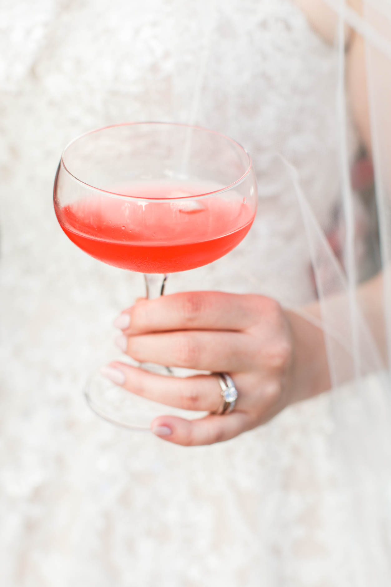 Bride holding red cocktail
