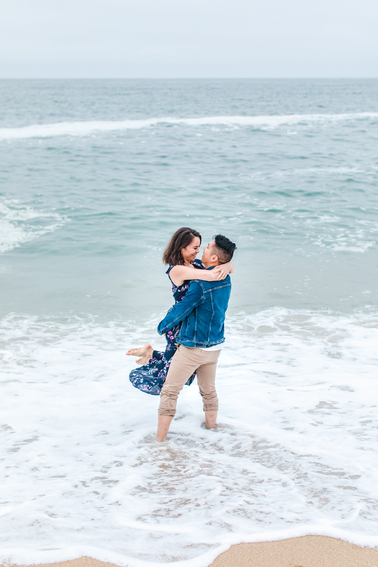 Groom Lifting Bride in ocean at Coast Dairies State Park Engagement Session