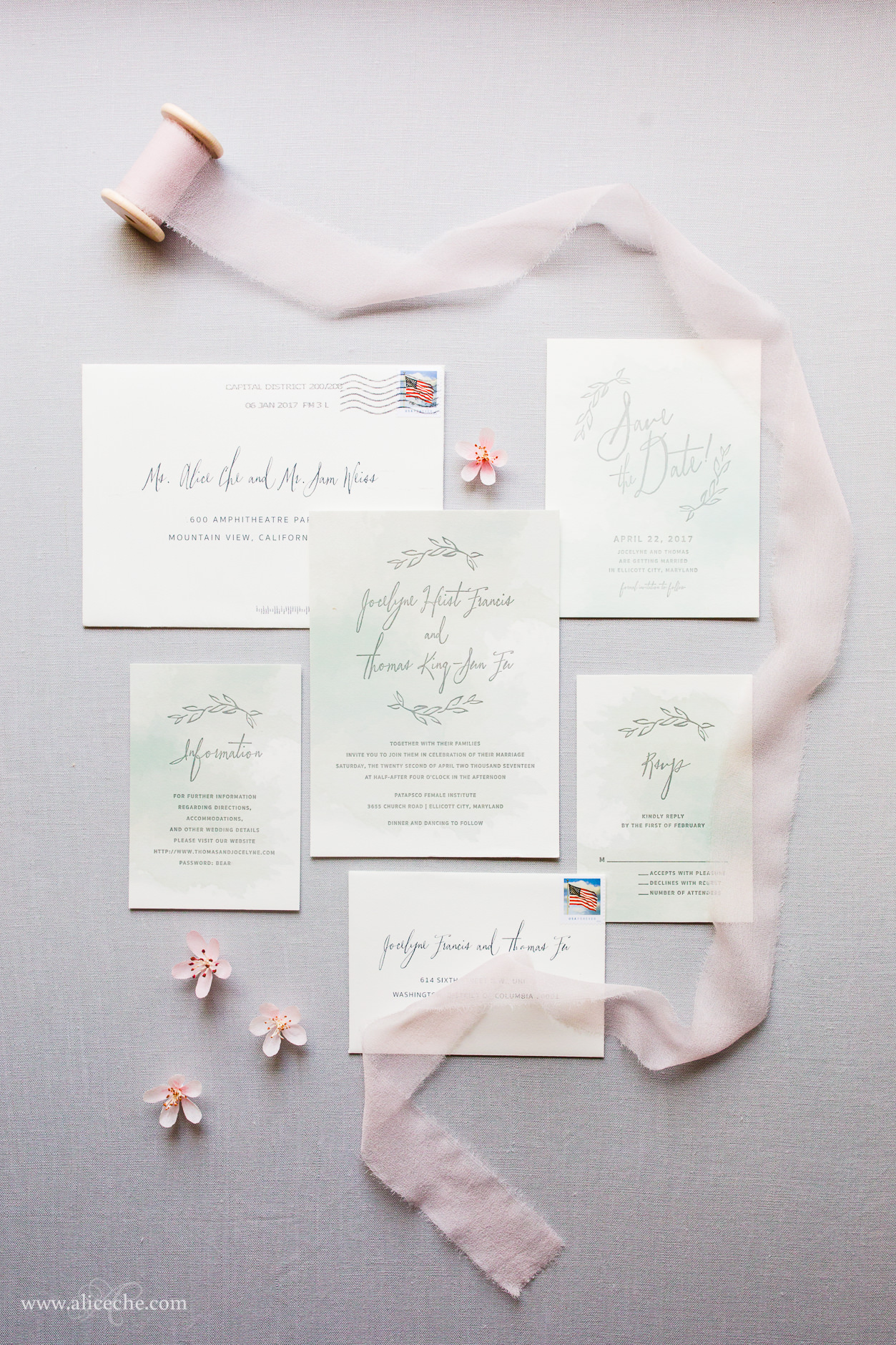 Watercolor wedding invitation styled with silk ribbon and crepe paper cherry blossoms
