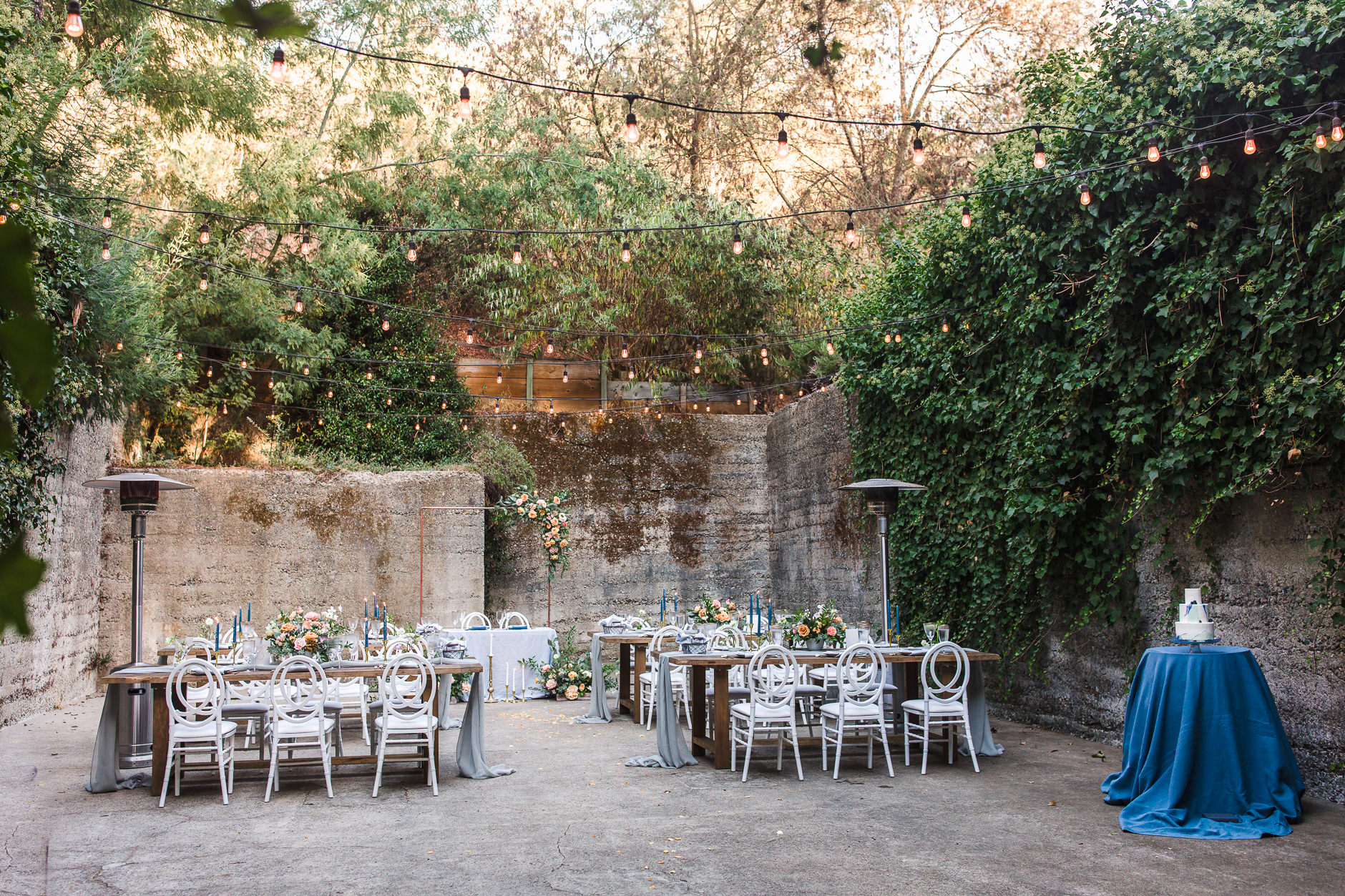 Wedding reception set up in Barrel Room at Sand Rock Farm with ivy covered walls and string lights