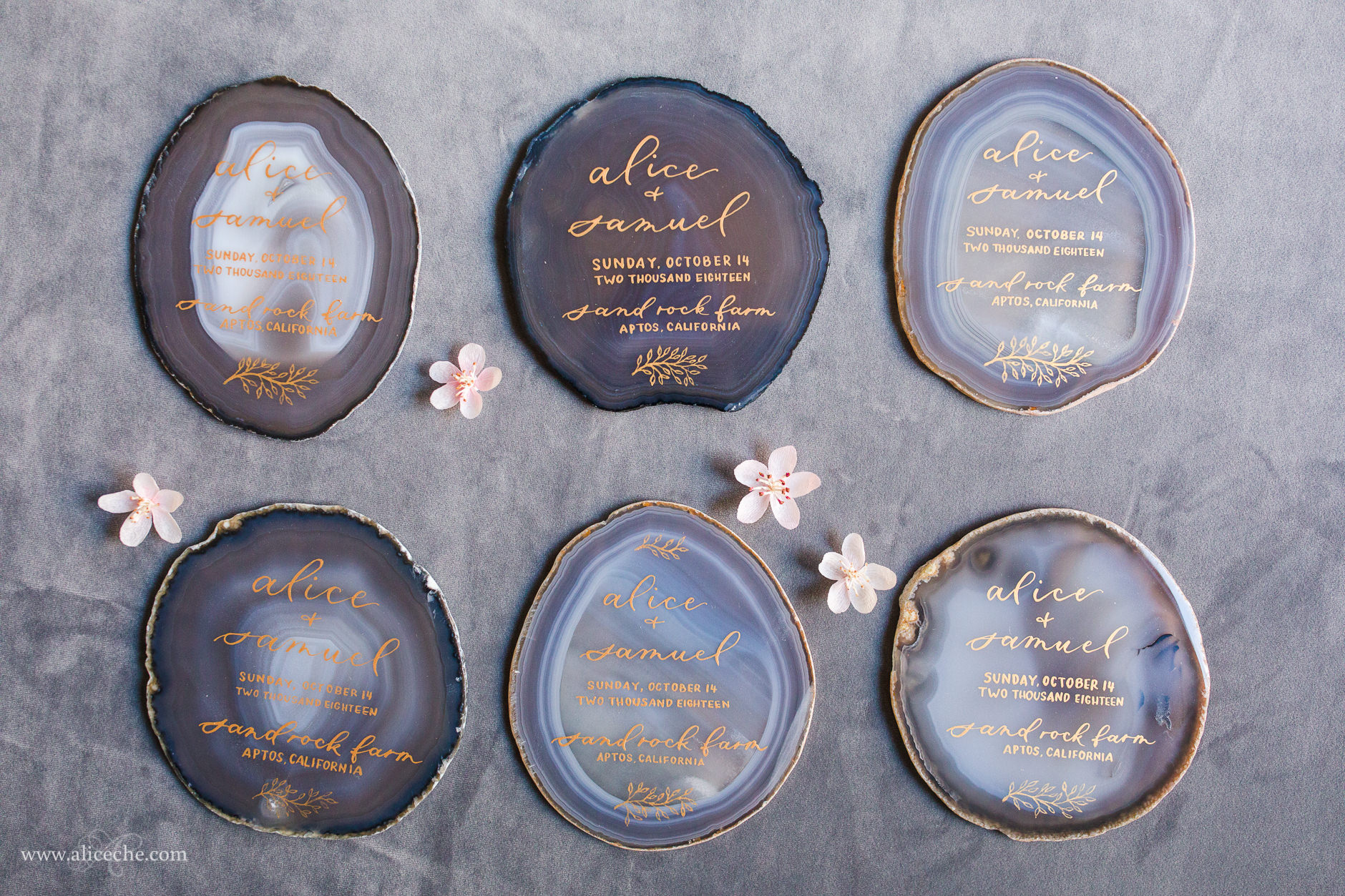 DIY wedding invite gold calligraphy on gray agate slices with crepe paper cherry blossoms