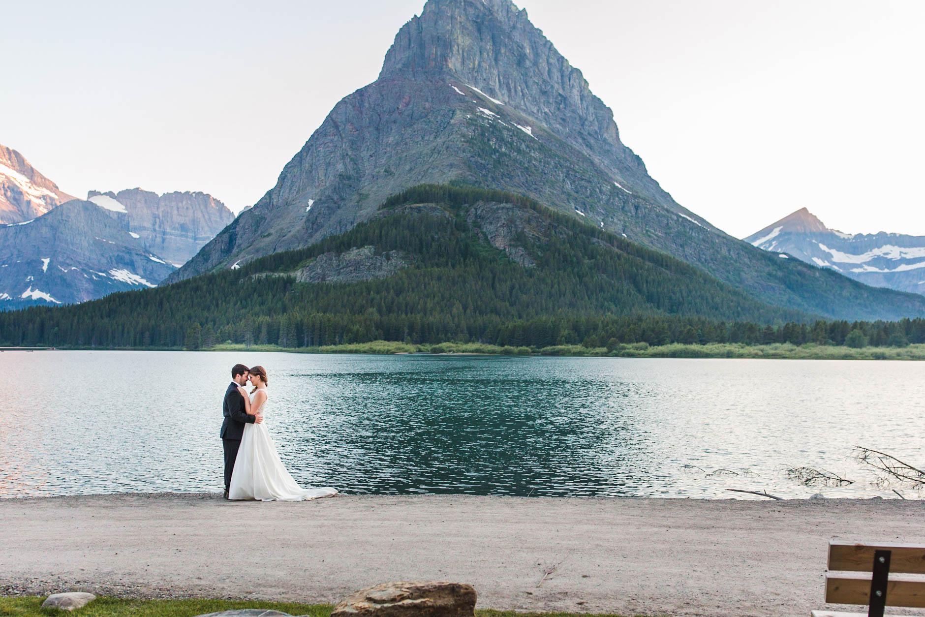 Glacier National Park destination wedding couple at Many Glacier in front of lake and mountain