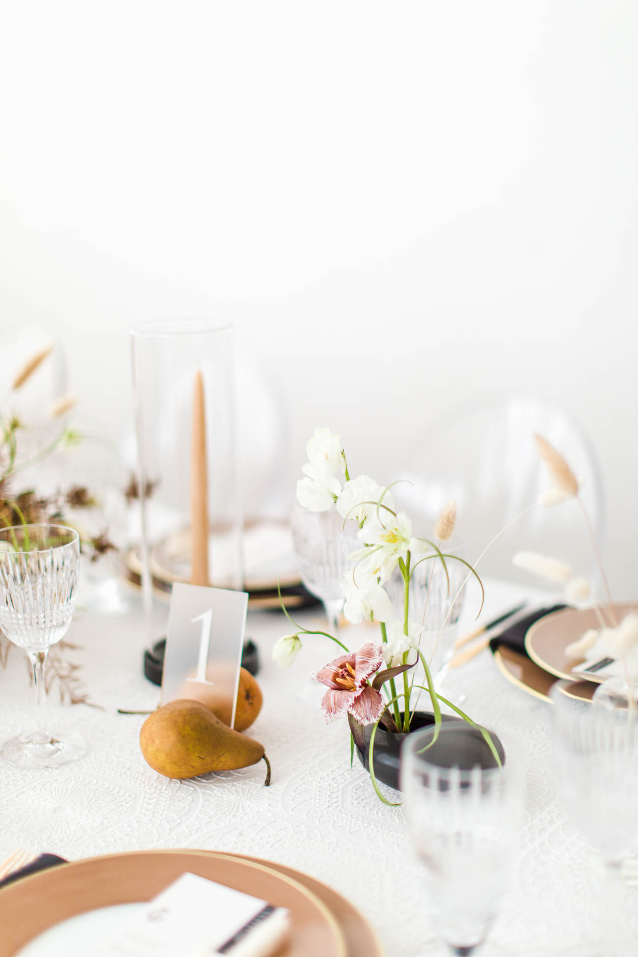 Tablescape with frosted table number and pears for modern warehouse wedding inspiration
