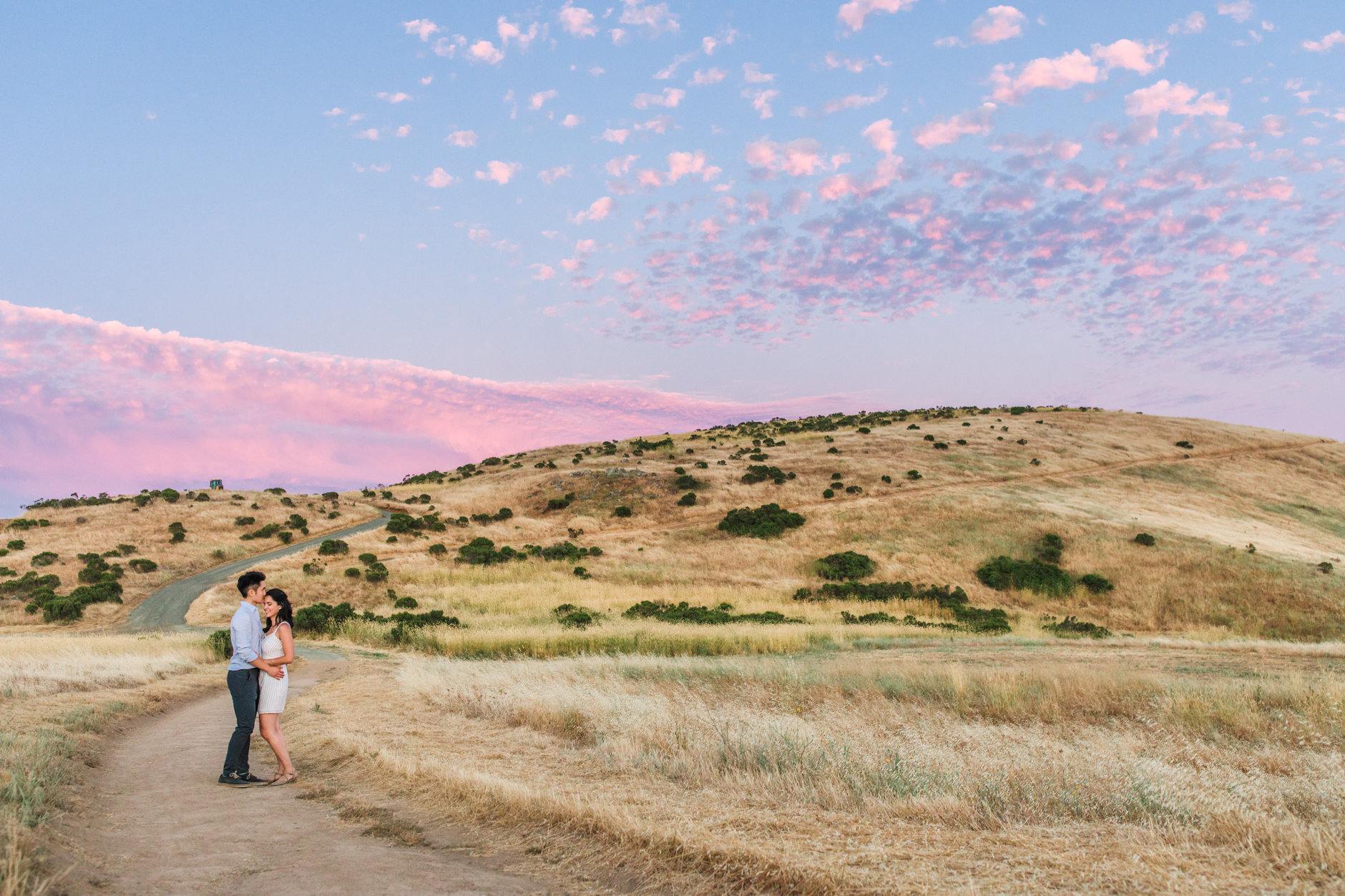 Groom kissing bride on forehead at sunset during Silicon Valley engagement session