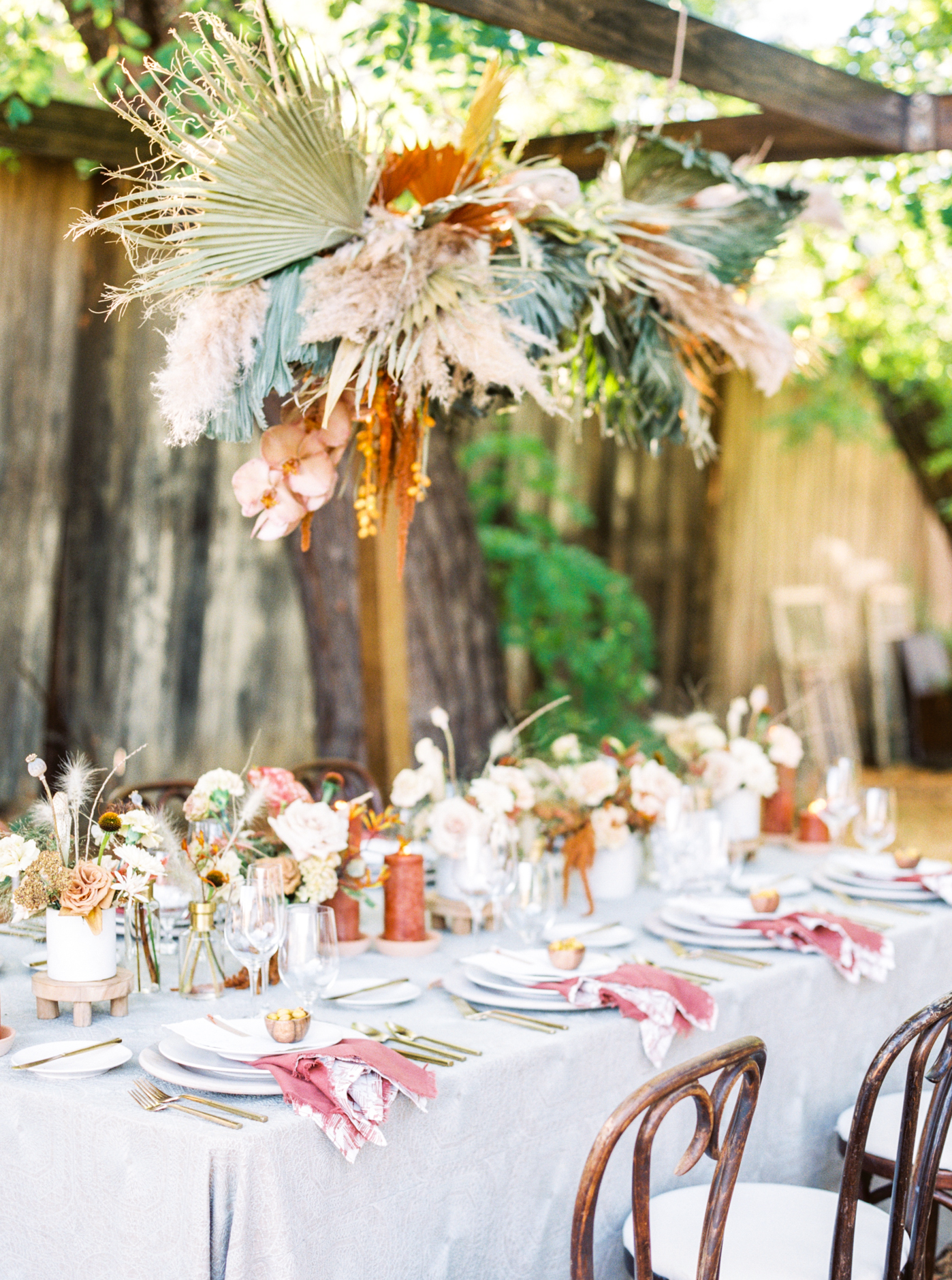 Side view of tablescape with hanging floral installation at Reinstein Ranch wedding by Alice Che Photography